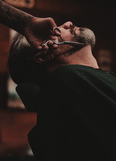 Close-up of a beard and neck trim in progress at Hardware Salon